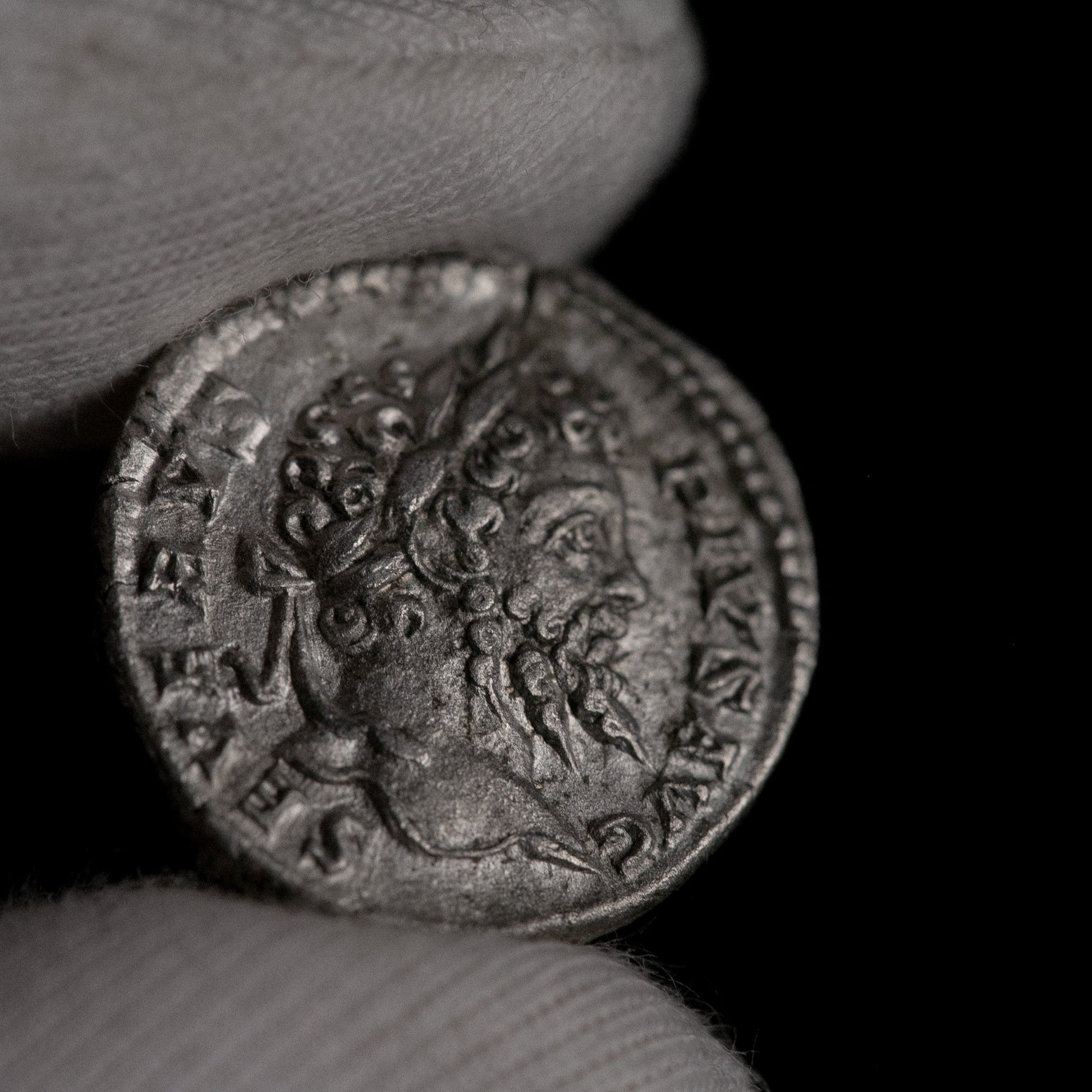Macro detail of Roman silver denarius of Septimius Severus, portrait close-up.