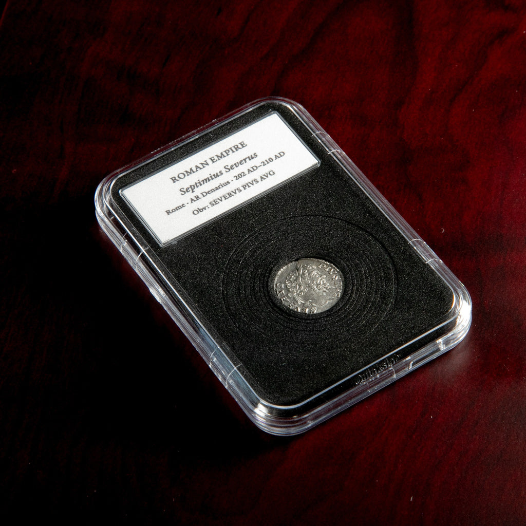 Roman silver denarius of Septimius Severus in protective slab with catalog label.