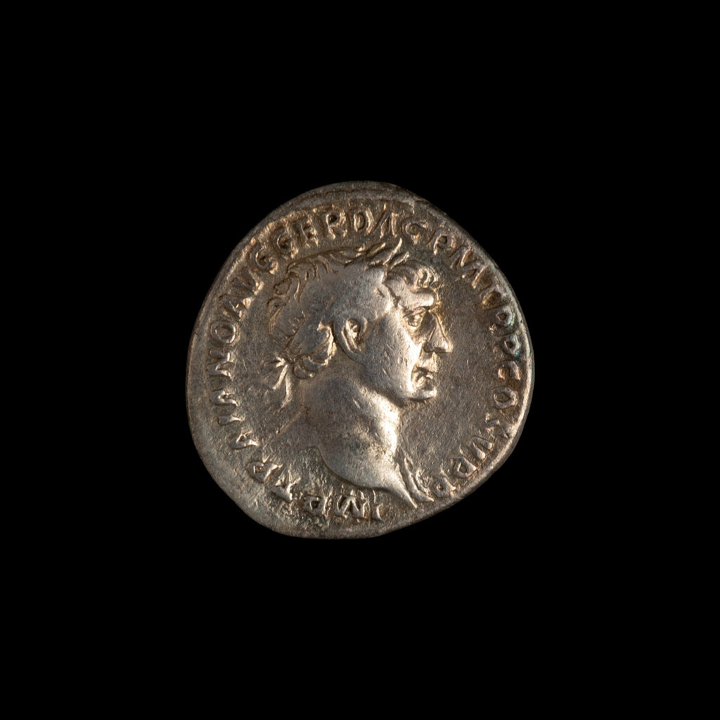 Obverse of Roman silver denarius of Trajan, legend IMP TRAIANO AVG GER DAC P M TR P COS V P P, radiate or laureate bust right.