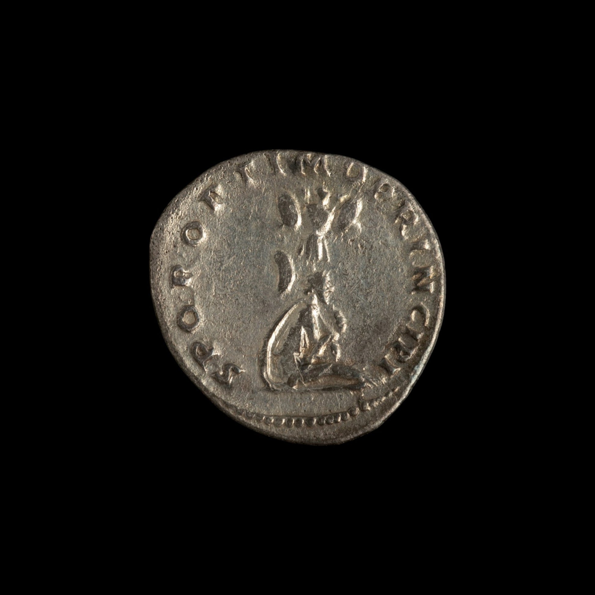 Reverse of Roman silver denarius of Trajan, showing Dacian seated right at base of trophy, legend S P Q R OPTIMO PRINCIPI.