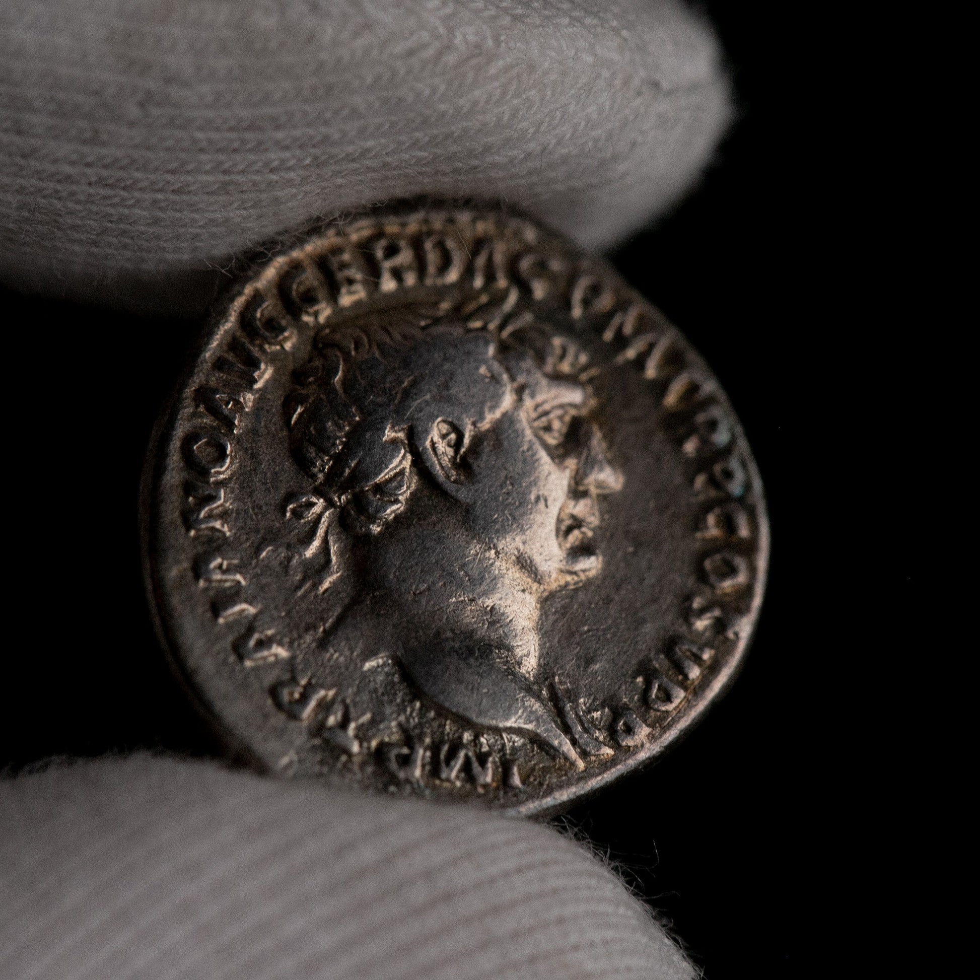 Macro detail of Roman silver denarius of Trajan, portrait close-up.