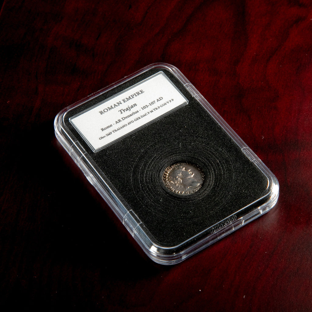 Roman silver denarius of Trajan in protective slab with catalog label.
