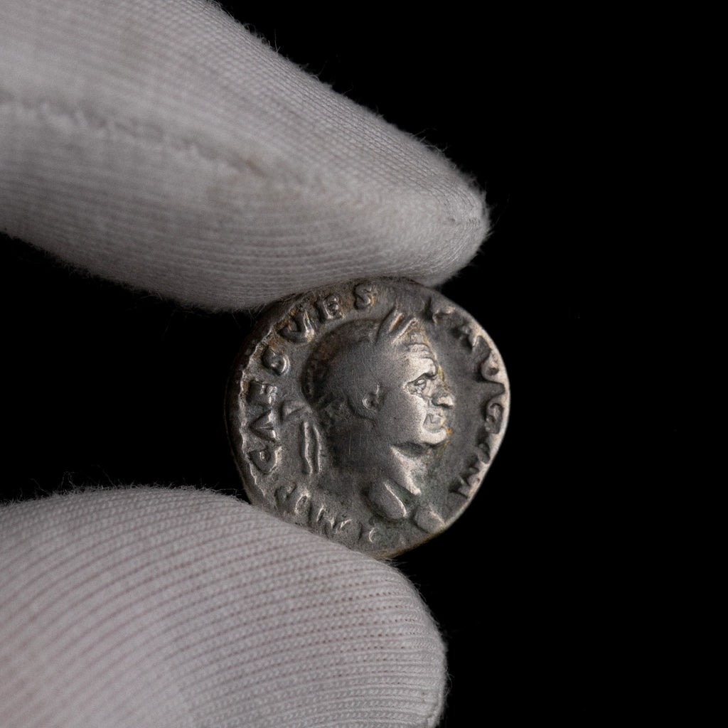 Macro detail of Roman silver denarius of Vespasian, portrait close-up.