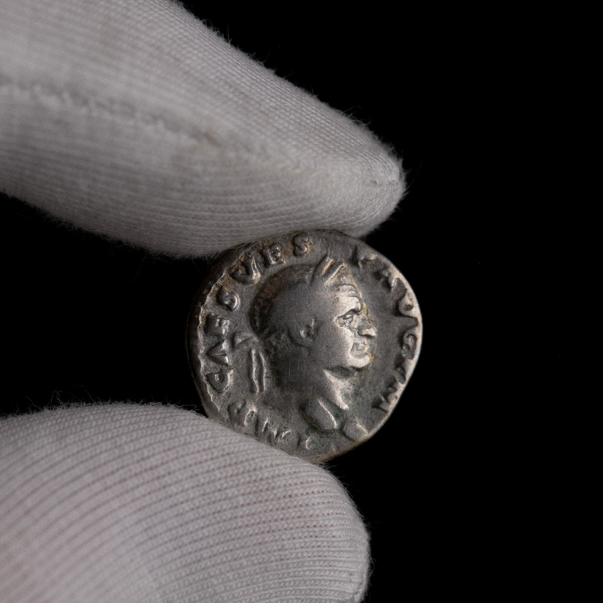 Macro detail of Roman silver denarius of Vespasian, portrait close-up.