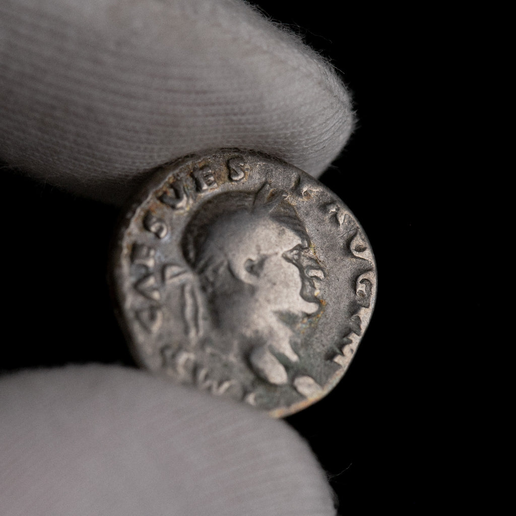 Macro detail of Roman silver denarius of Vespasian, portrait close-up.