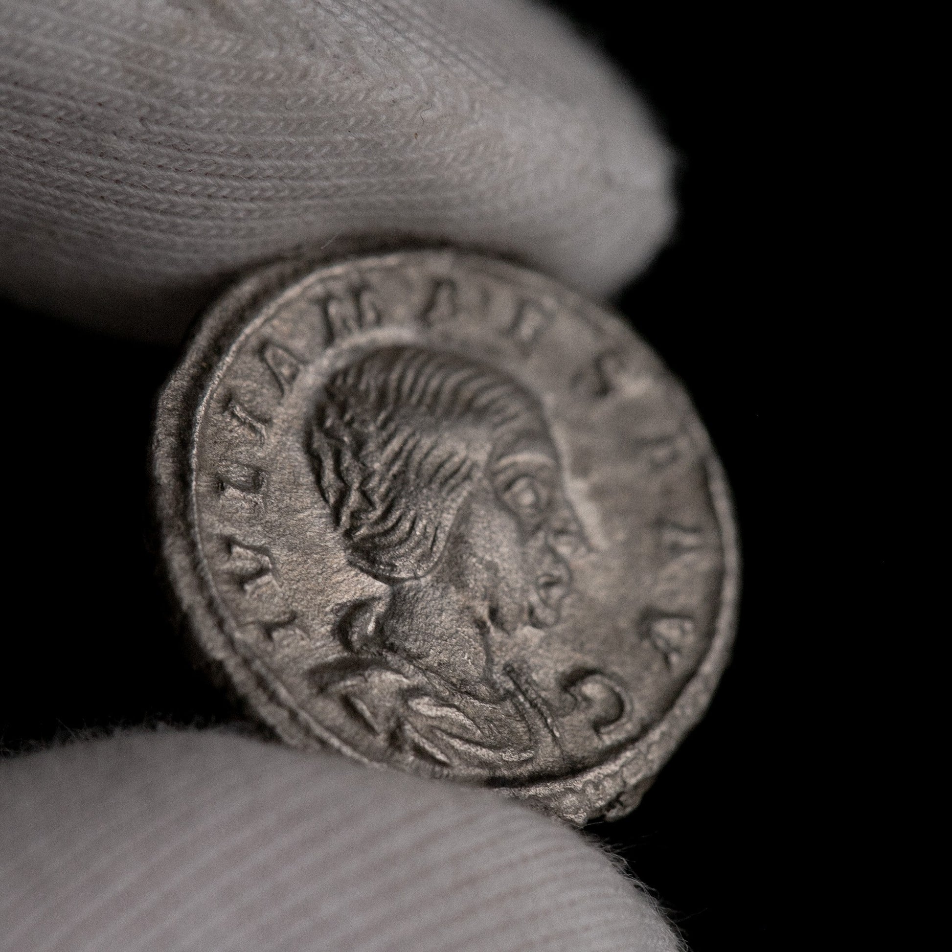 Macro detail of Roman silver denarius of Julia Maesa, portrait close-up.