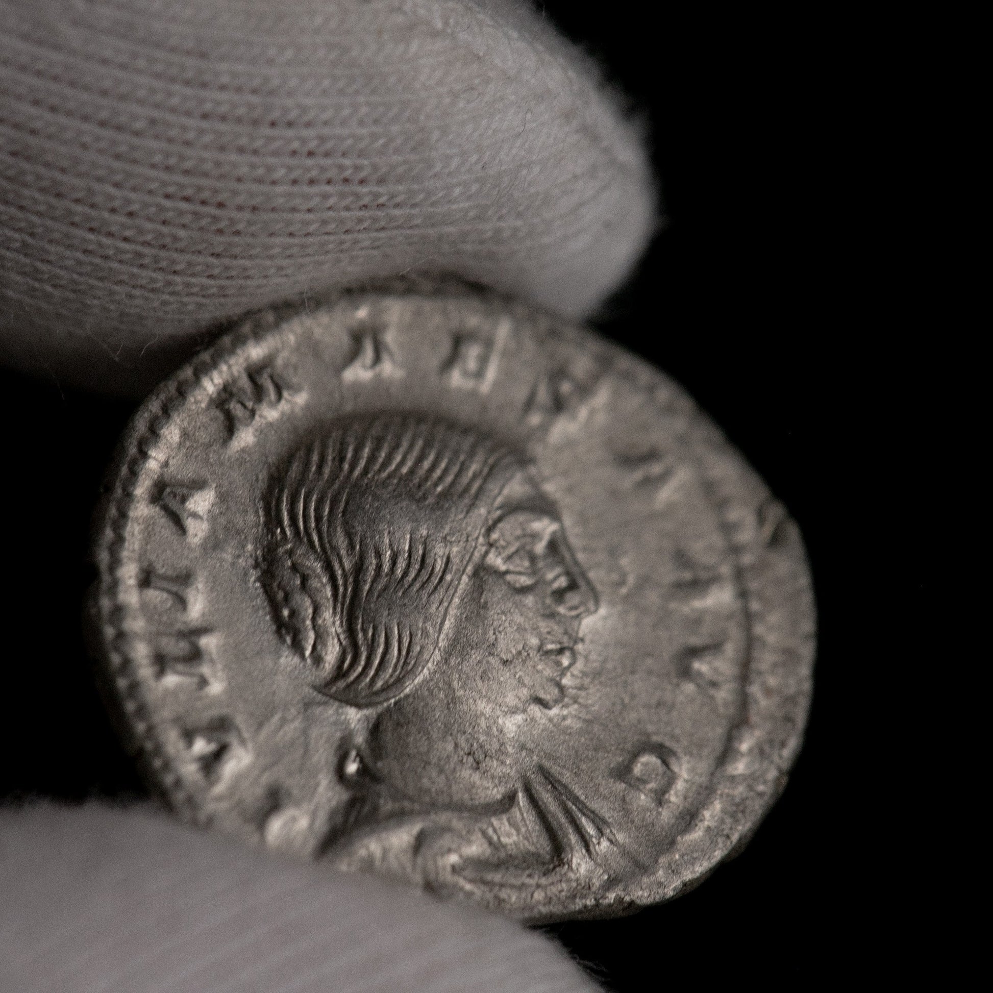 Macro detail of Roman silver denarius of Julia Maesa, portrait close-up.