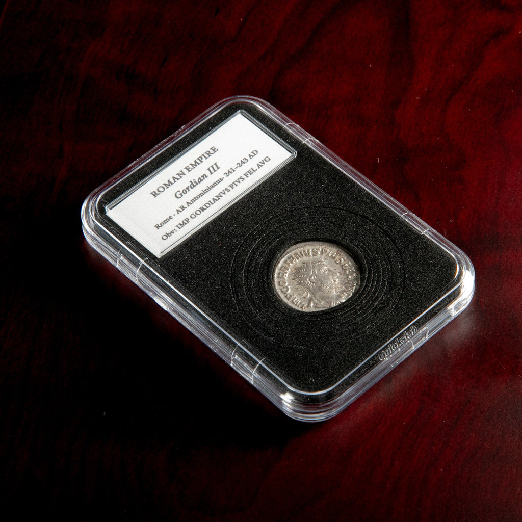 Roman silver antoninianus of Gordian III in protective slab with catalog label.