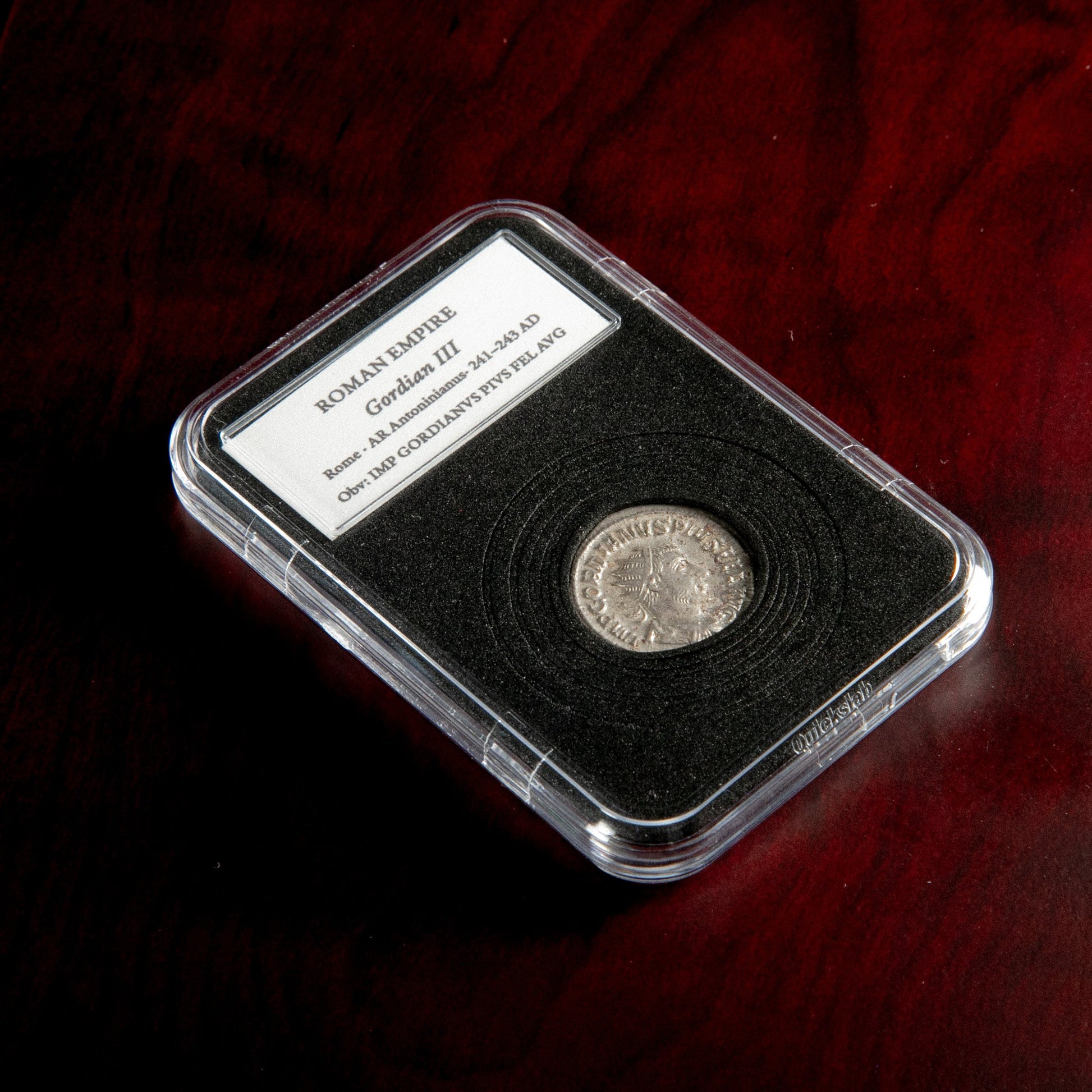 Roman silver antoninianus of Gordian III in protective slab with catalog label.