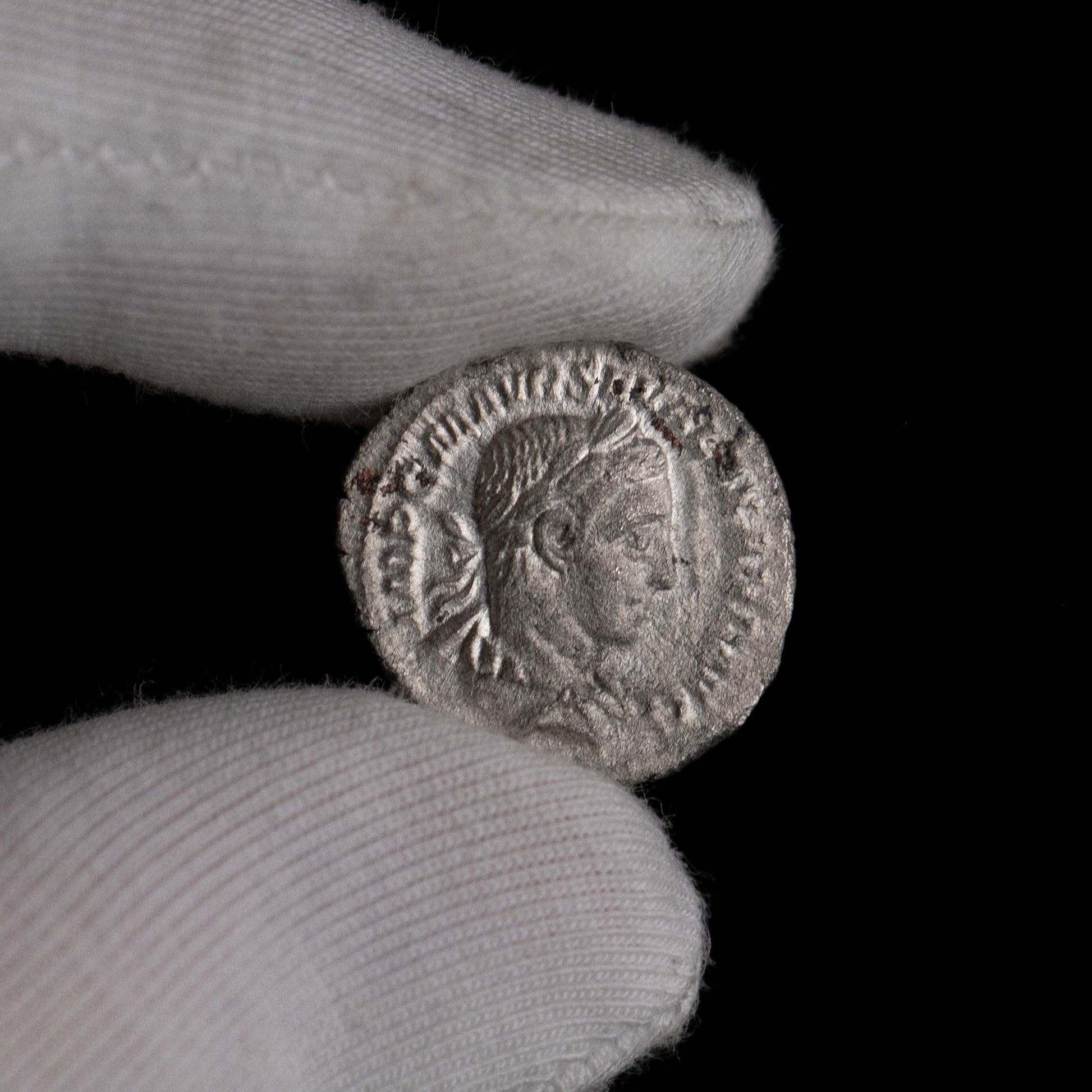 Macro detail of Roman silver denarius of Severus Alexander, portrait close-up.