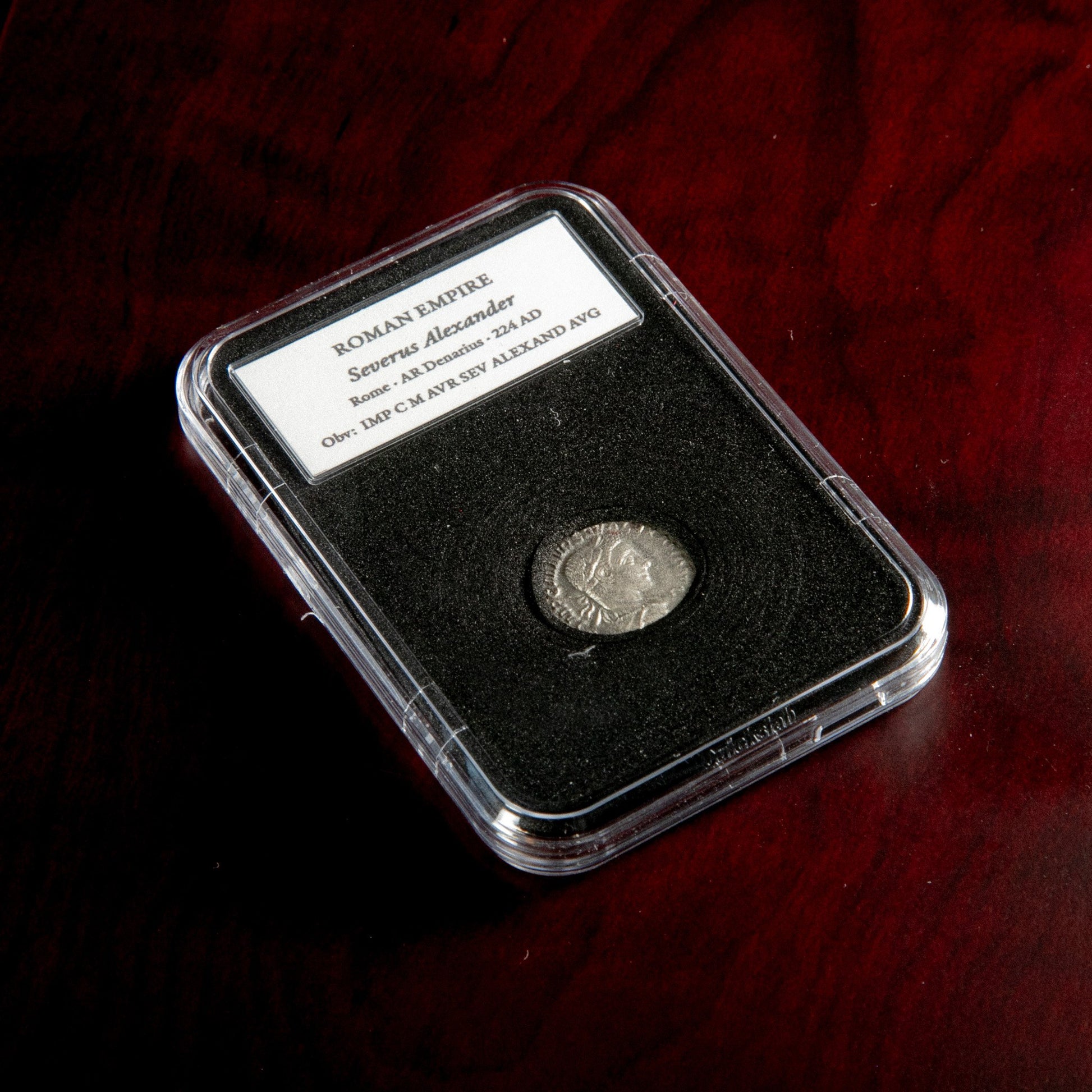 Roman silver denarius of Severus Alexander in protective slab with catalog label.