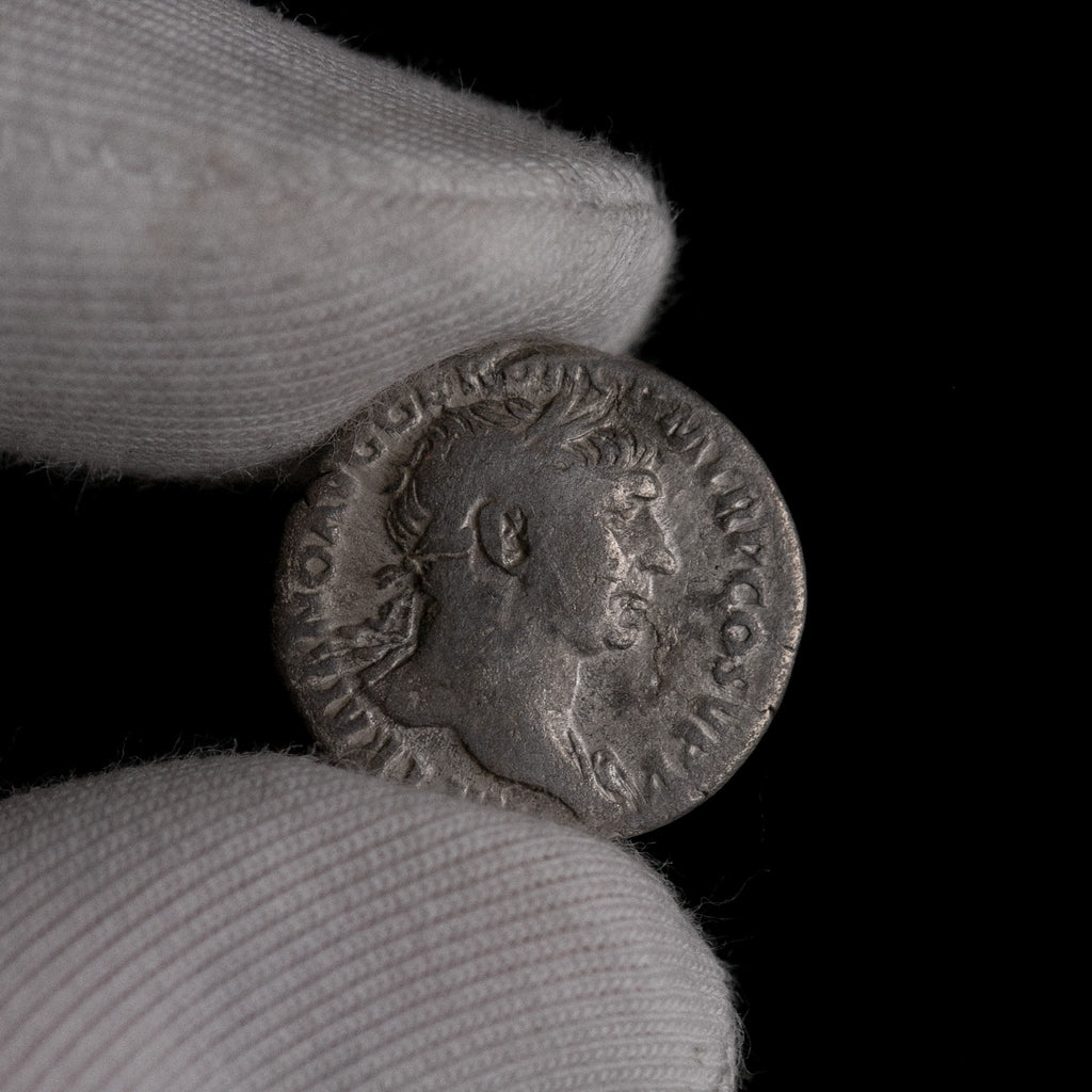 Macro detail of Roman silver denarius of Trajan, portrait close-up.