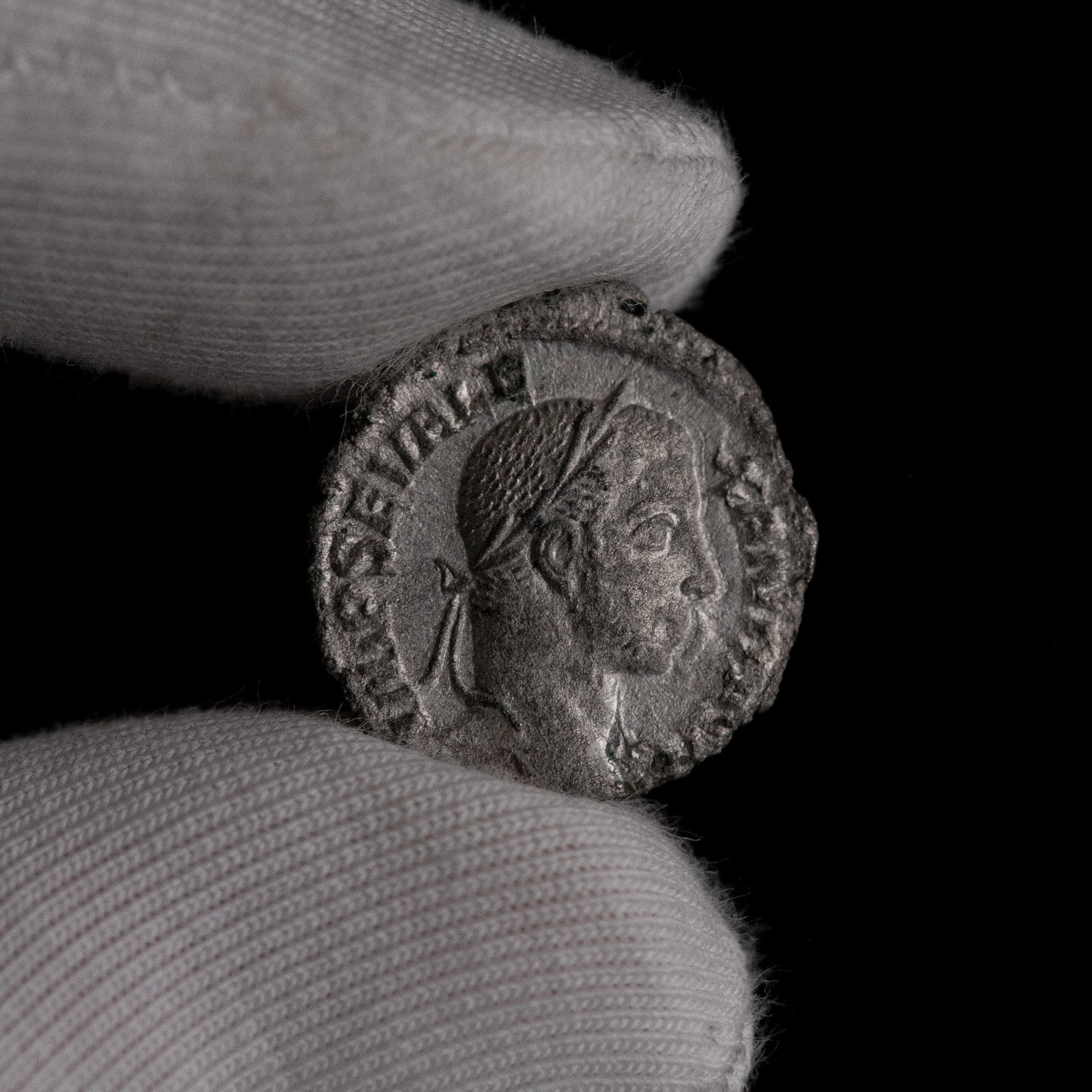 Macro detail of Roman silver denarius of Severus Alexander, portrait close-up.