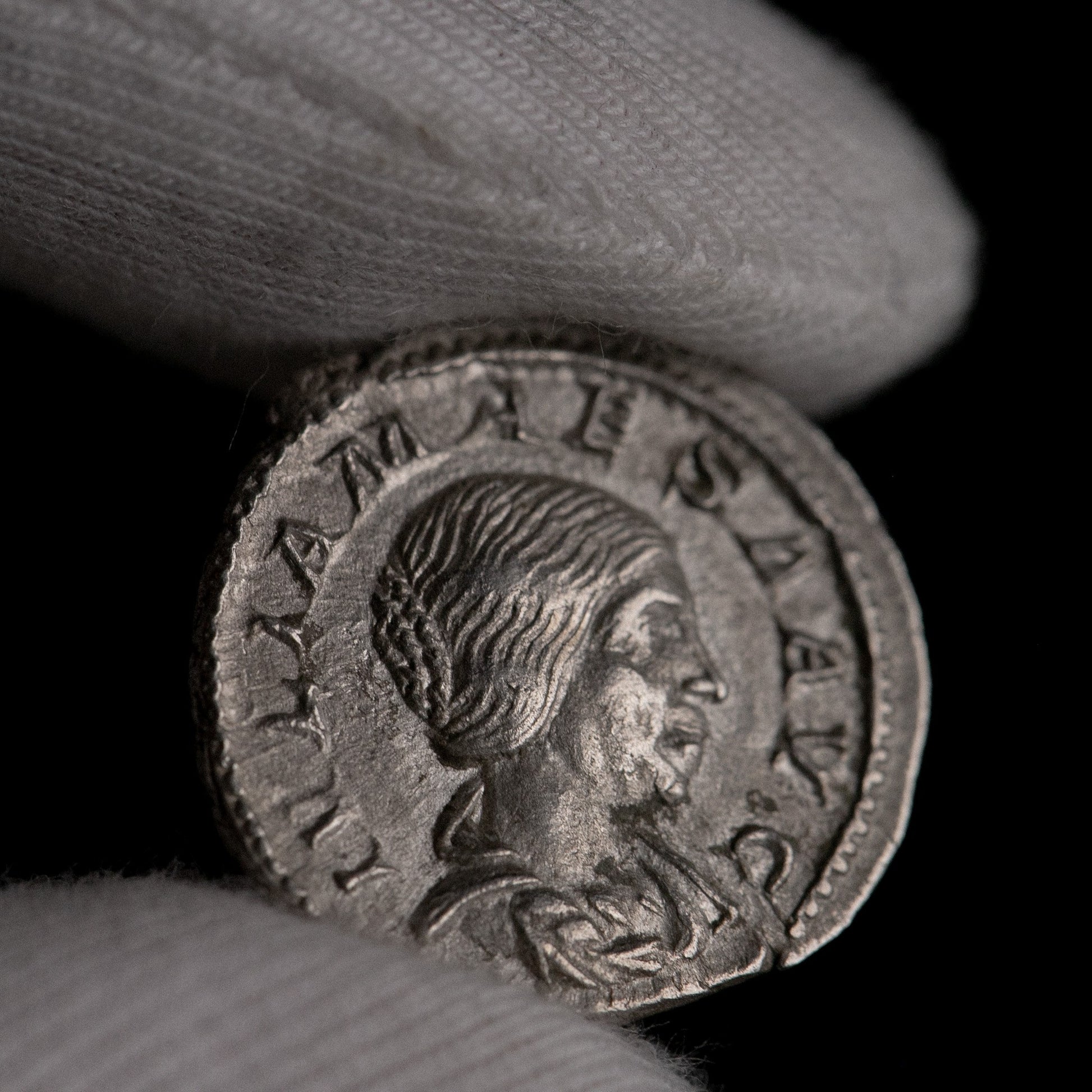 Macro detail of Roman silver denarius of Julia Maesa, portrait close-up.