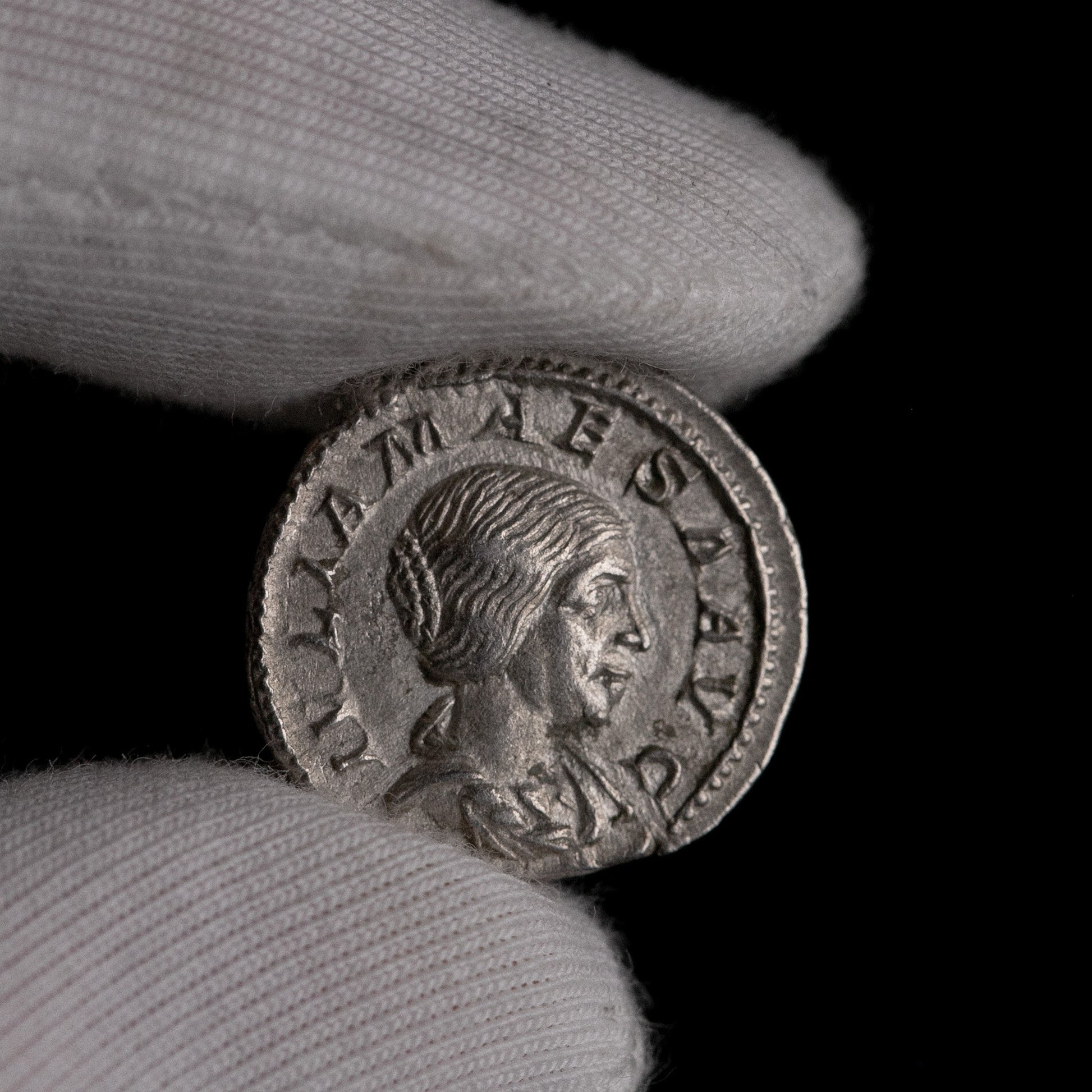 Macro detail of Roman silver denarius of Julia Maesa, portrait close-up.