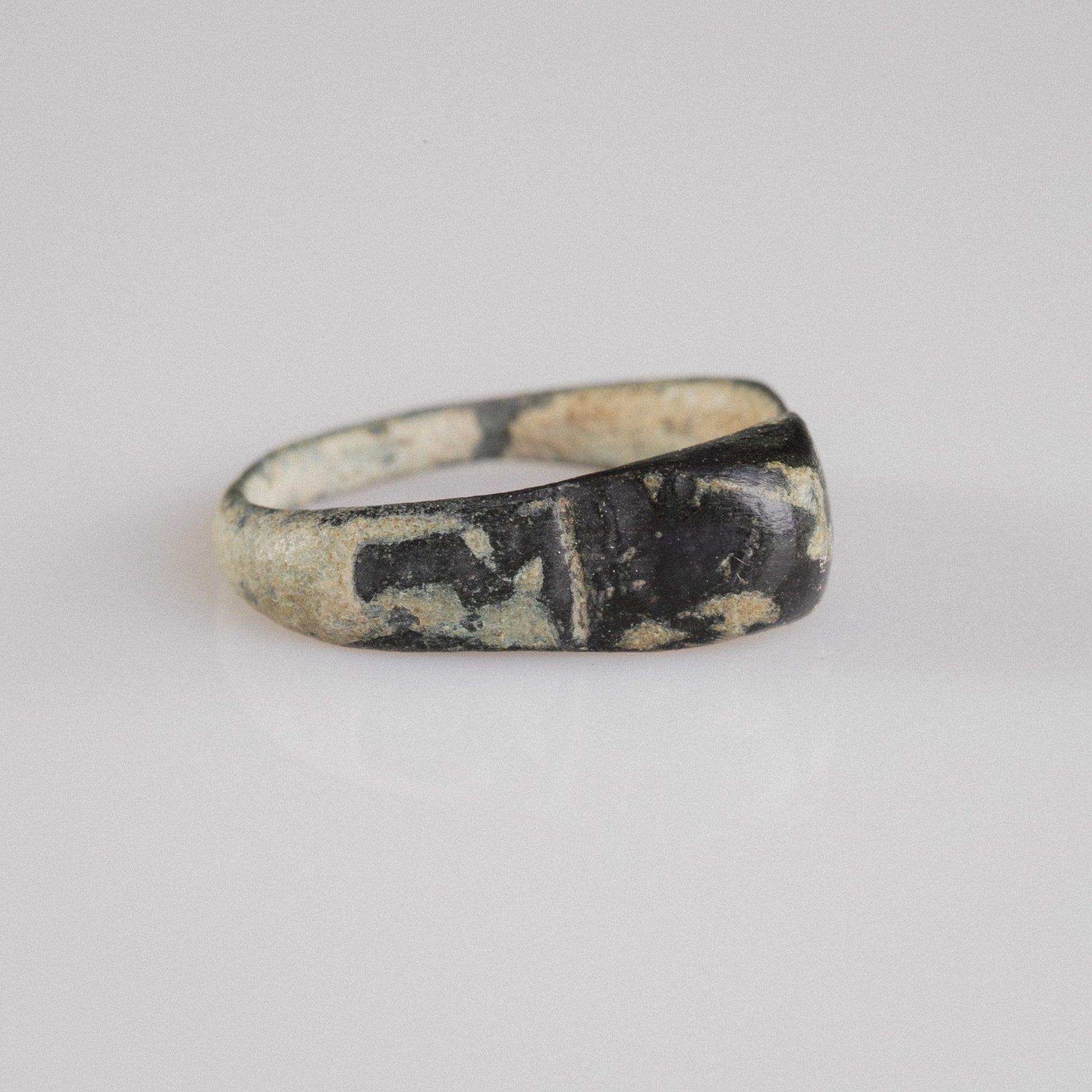 Roman bronze ring Numeria, three-quarter view showing sloping shoulders and tenorite patina