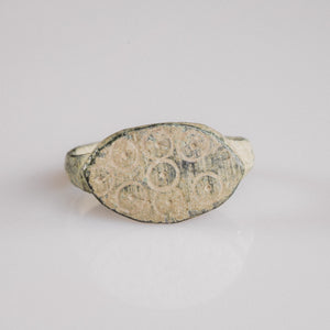 Late Roman bronze signet ring Numerius Secundus with ring-and-dot punch motifs on oval bezel, top view