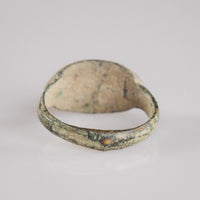 Interior view of Roman bronze signet ring Numerius Secundus showing hoop wear and soil encrustation