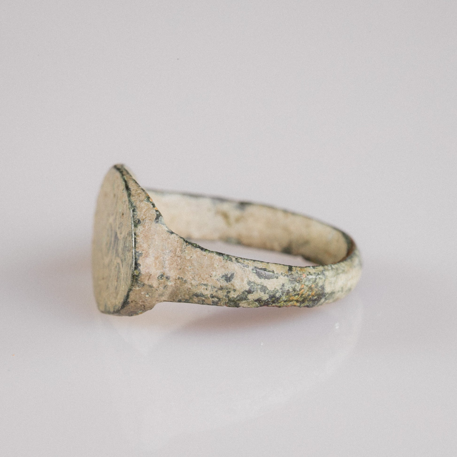 Bezel-end view of Roman bronze ring Numerius Secundus highlighting integral cast construction