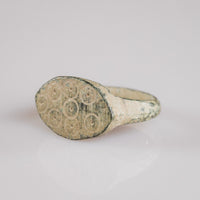 Close angled view of Roman bronze ring Numerius Secundus with ring-and-dot Kreisaugenpunze motifs