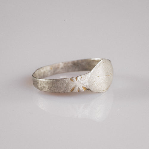 Side profile of Medieval silver ring Aldwin showing radiating star motif on shoulder