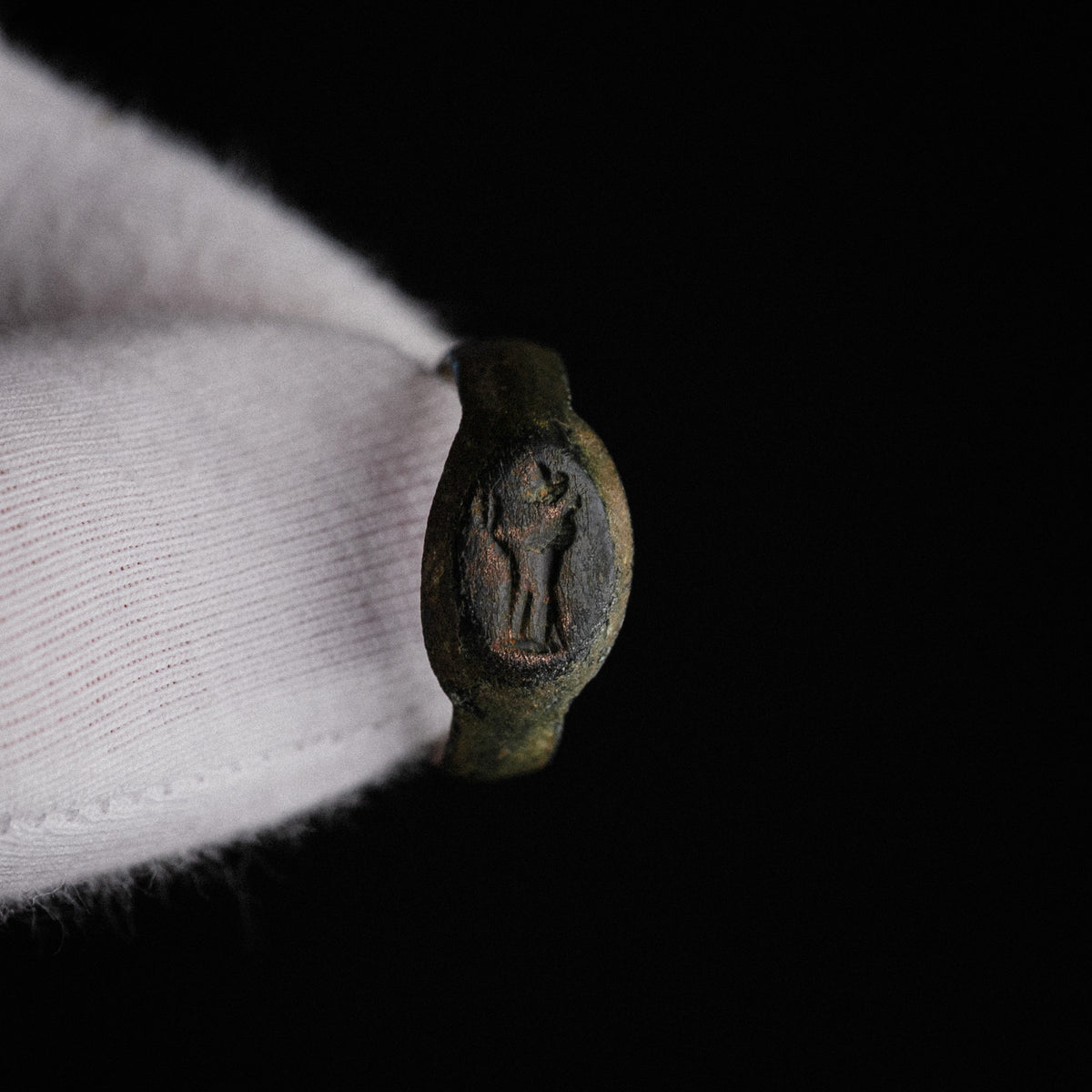 Close-up of Numerius Faber Roman bronze ring showing engraved standing figure intaglio