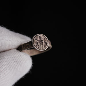 Byzantine silver signet ring Danielos held in gloved hand, showing Daniel orant bezel scene