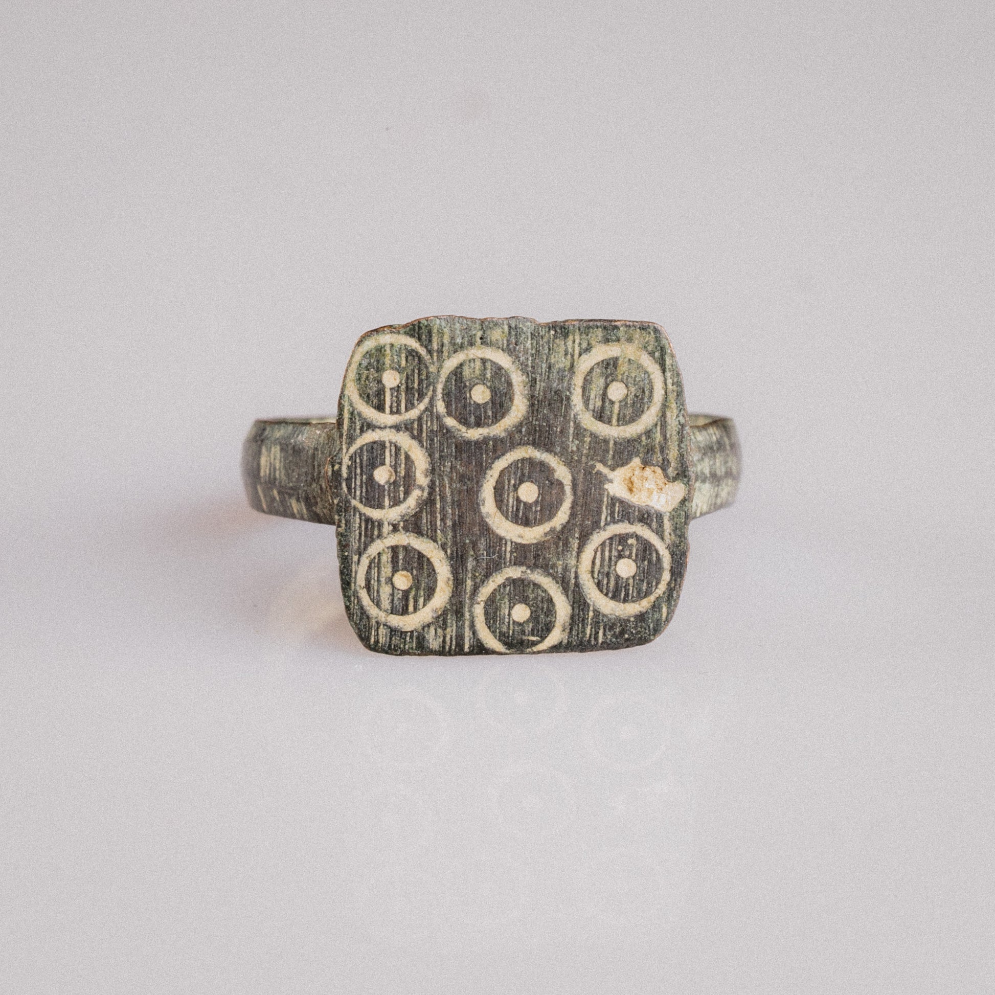 Top view of Novenarius Late Roman bronze signet ring showing square bezel and symmetrical hoop
