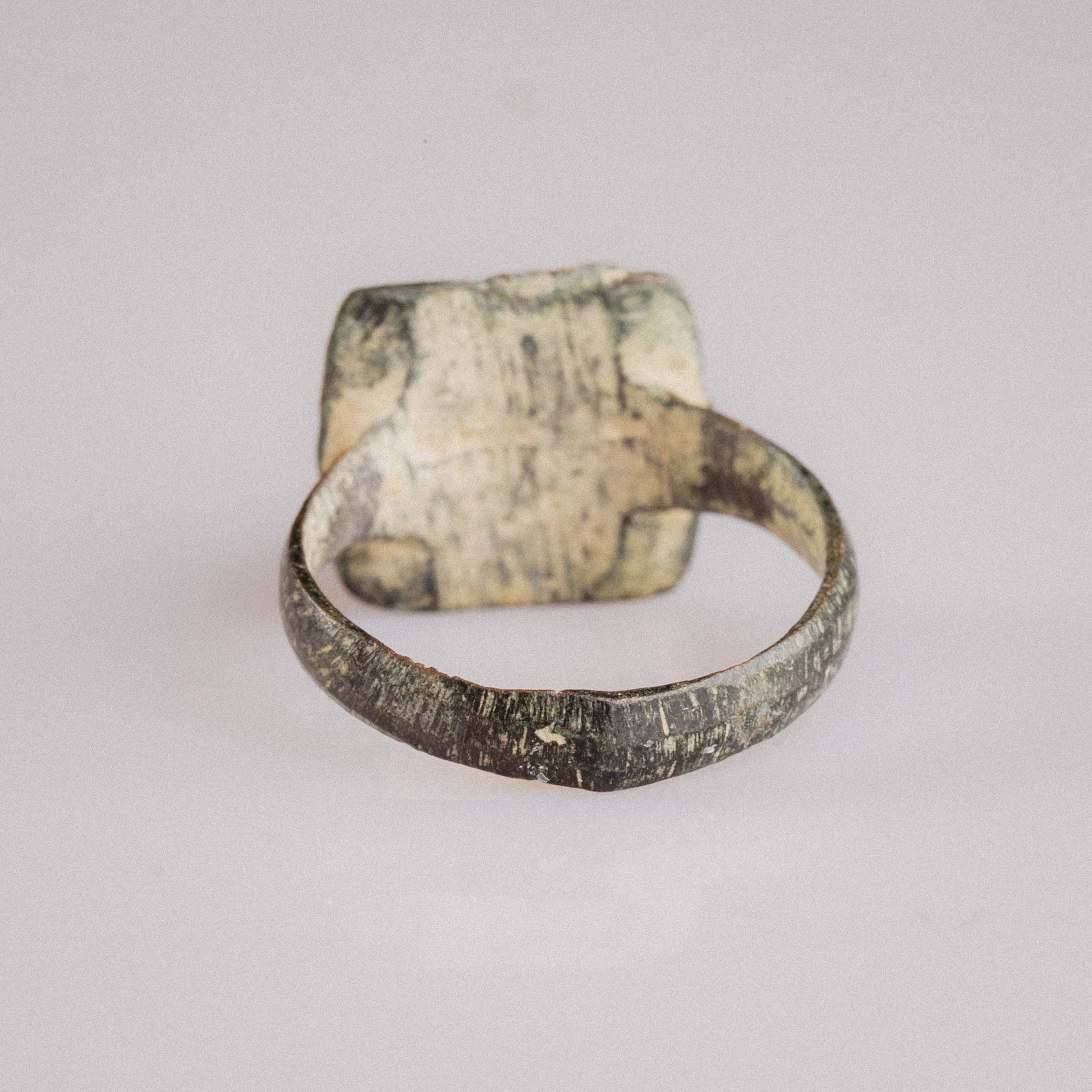 Rear view of Novenarius Roman bronze ring showing plain inner hoop and bezel underside