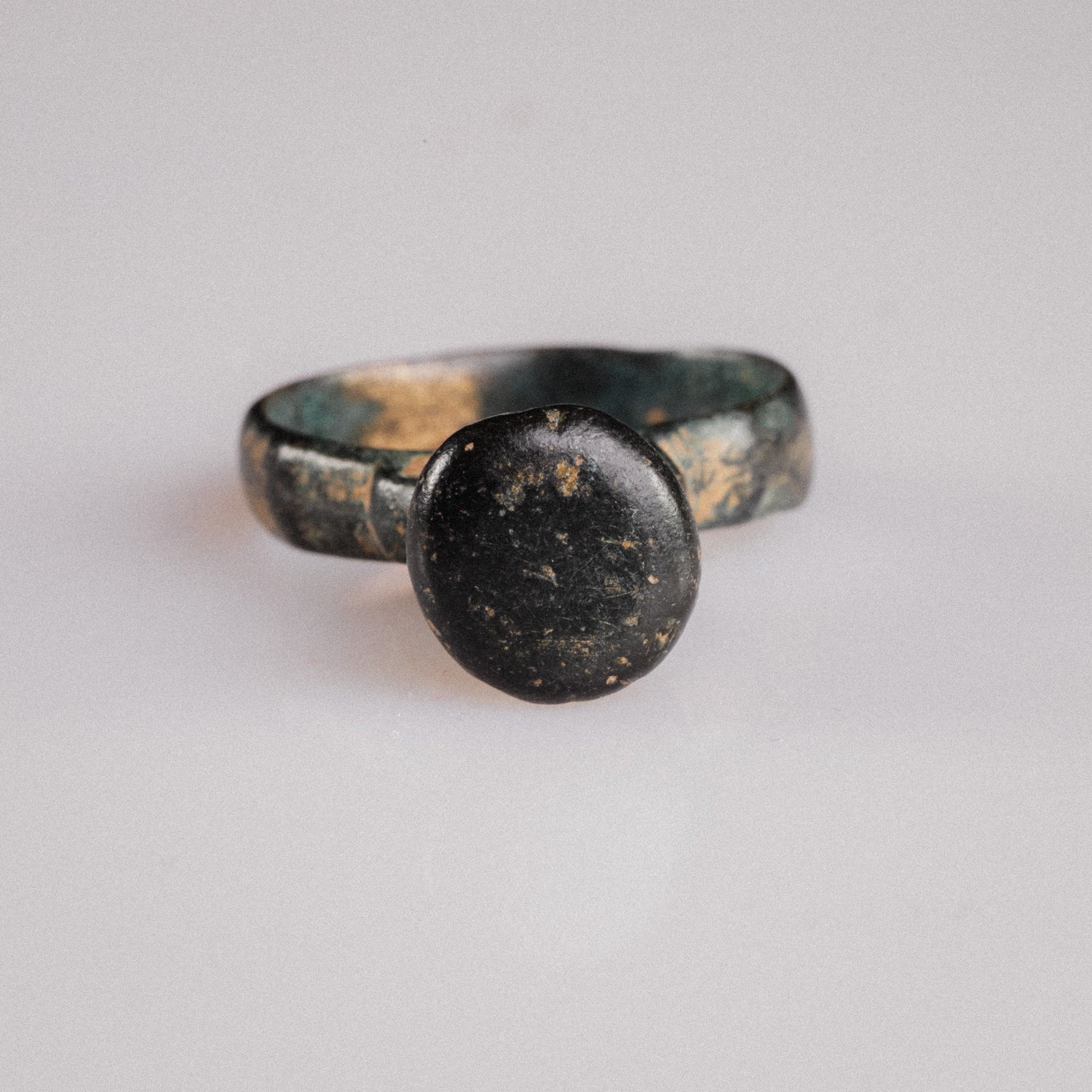 Top view of late Roman bronze ring Numerius Magnus showing smooth flat circular bezel and patina