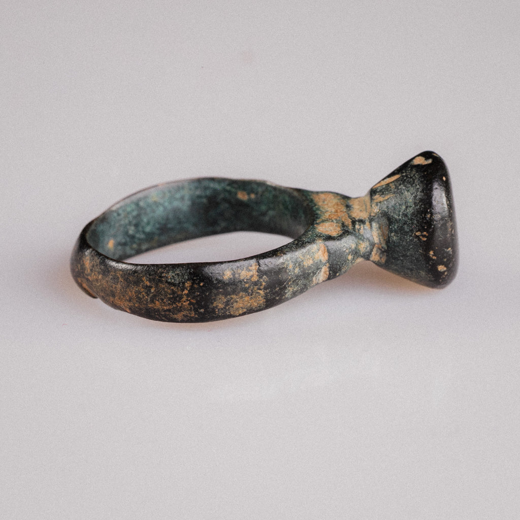 Angled view of late Roman bronze ring Numerius Magnus showing pedestal and tapering D-section hoop
