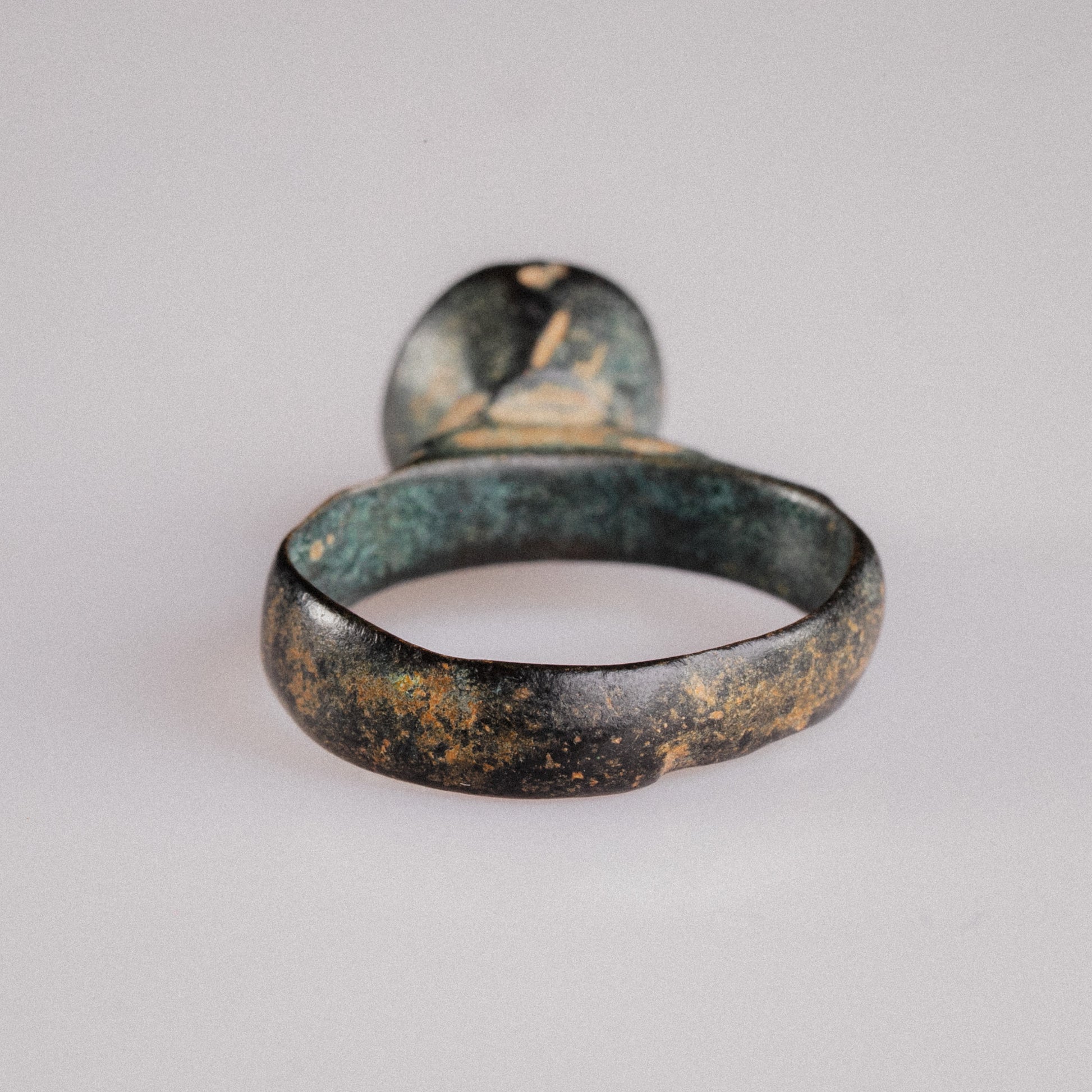 Rear three-quarter view of Roman bronze signet Numerius Magnus showing inner hoop green malachite patina