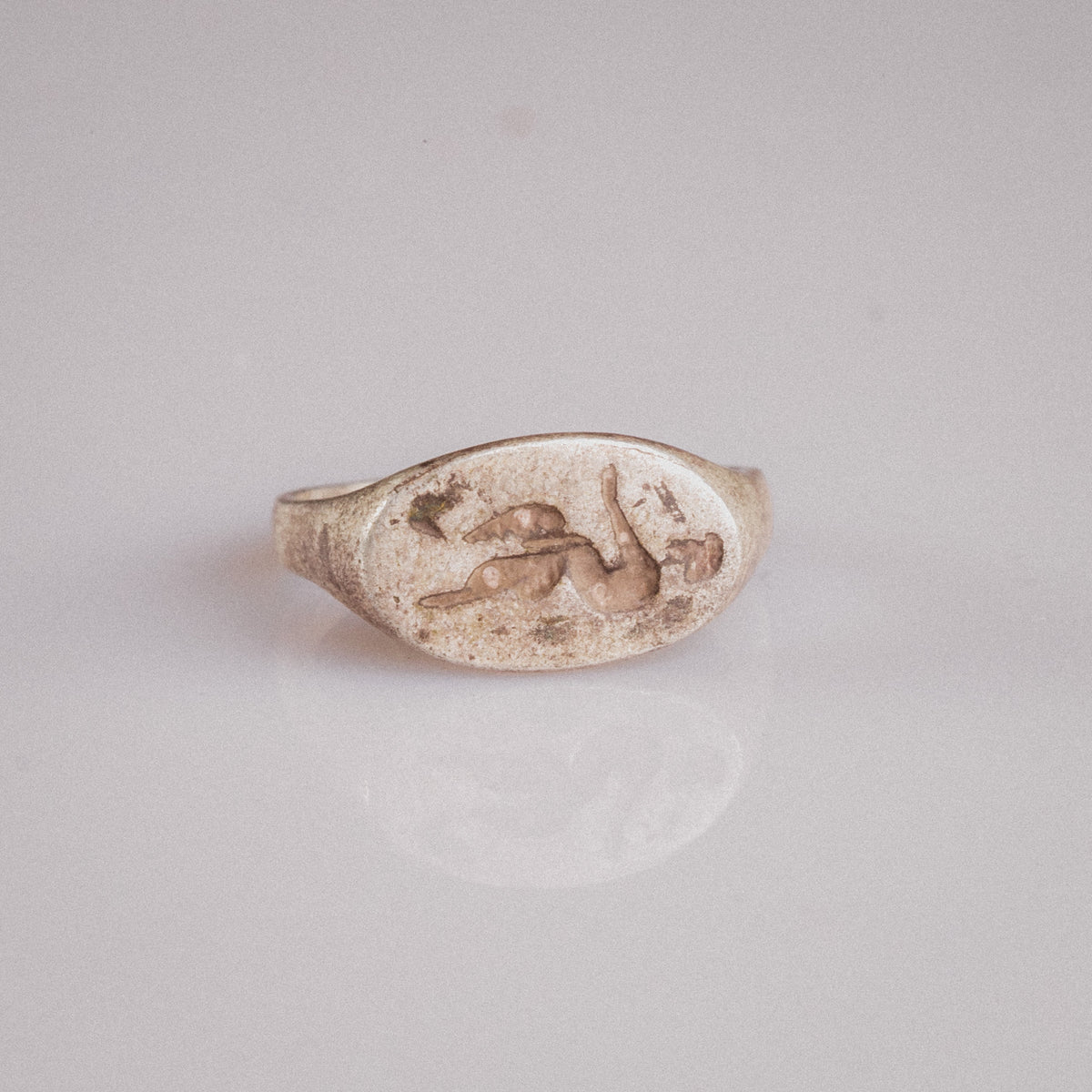 Top-down view of Roman silver ring Faunus showing full faun engraving on bezel