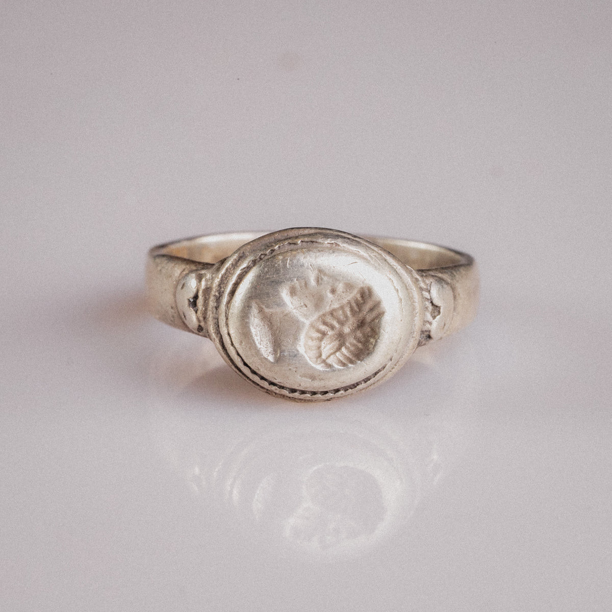 Front view of Roman silver signet ring Lavinia with rope-bordered oval bezel