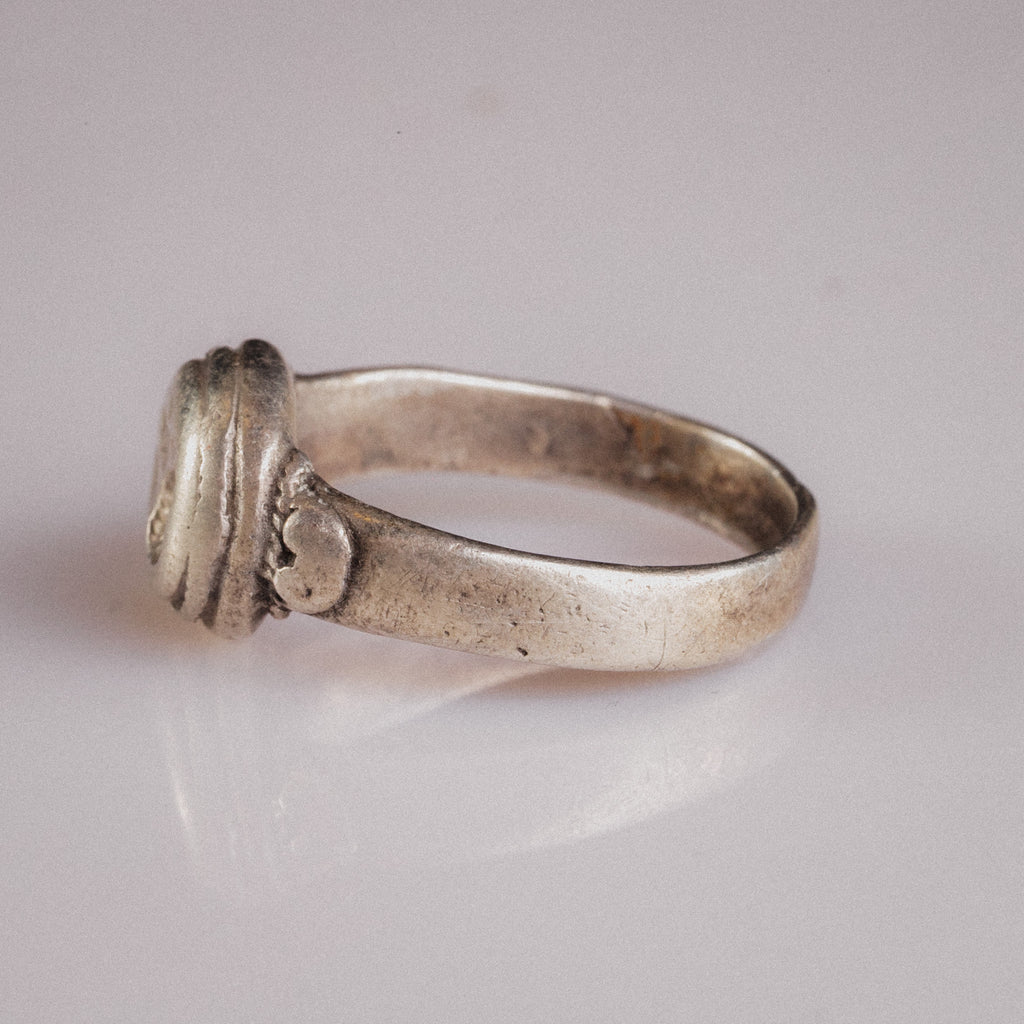 Angled view of Lavinia ring showing hoop taper and silver sulfide tarnish in recesses