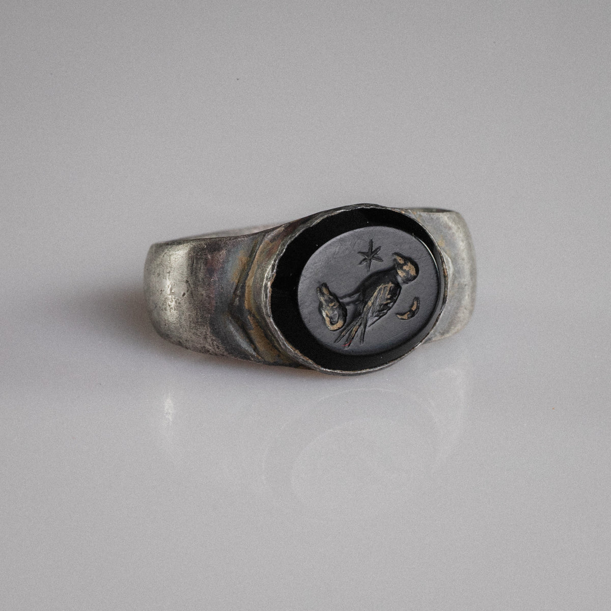 Roman silver signet ring Numerius Aquilus with eagle, star and crescent intaglio on dark stone