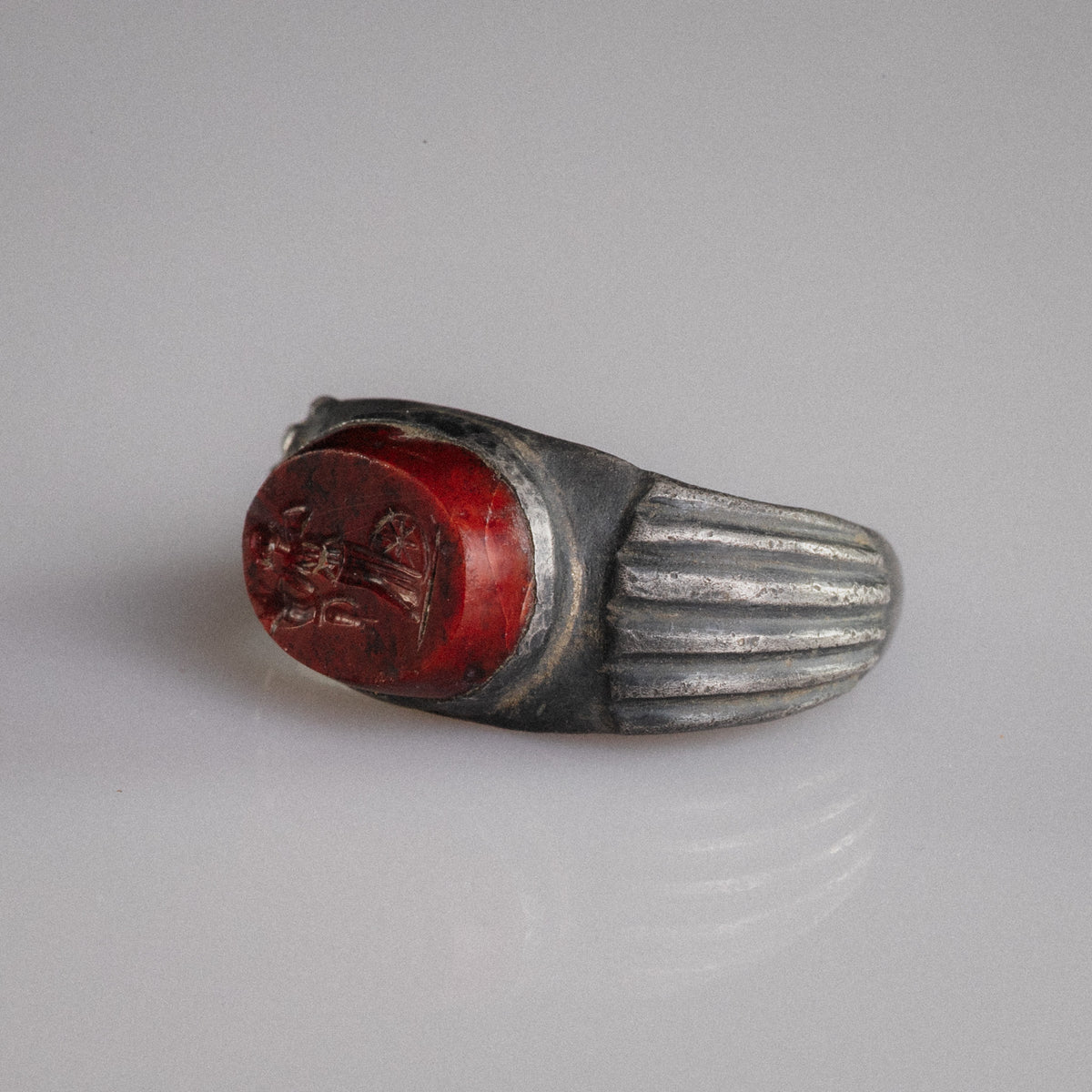 Three-quarter view of Roman silver signet ring Fortunata showing bezel and fluted shoulder detail
