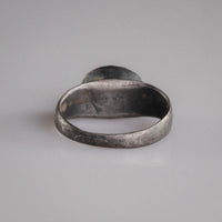 Interior view of Roman silver ring Sereia showing original patina and burial deposits inside the hoop