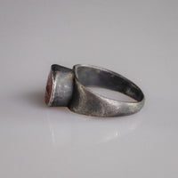 Angled view of Roman silver ring Sereia with garnet intaglio of Isis-Fortuna with cornucopia and rudder