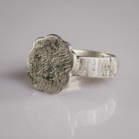Close-up of Florian medieval silver bezel with malachite green engraving in the star motif