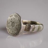 Three-quarter view of medieval silver ring Stavros highlighting cross bezel and shoulder hatching