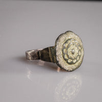 Islamic silver ring Gulizar showing gilt rosette bezel and stepped shoulder in three-quarter view