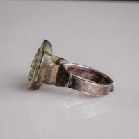 Angled view of Islamic silver ring Gulizar showing hoop, stepped shoulder, and patinated bezel