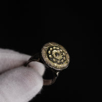 Studio close-up of Islamic silver ring Gulizar showing gilt rosette against dark oxidized ground