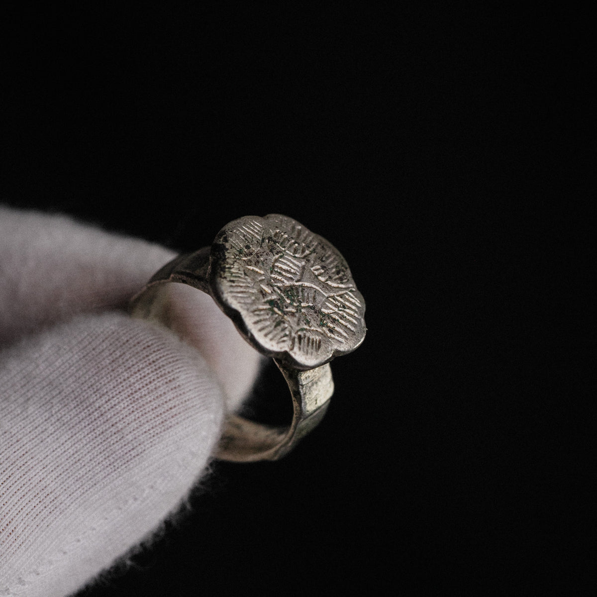 Macro detail of Florian medieval silver ring showing crisp engraved star and hatched radiating strokes