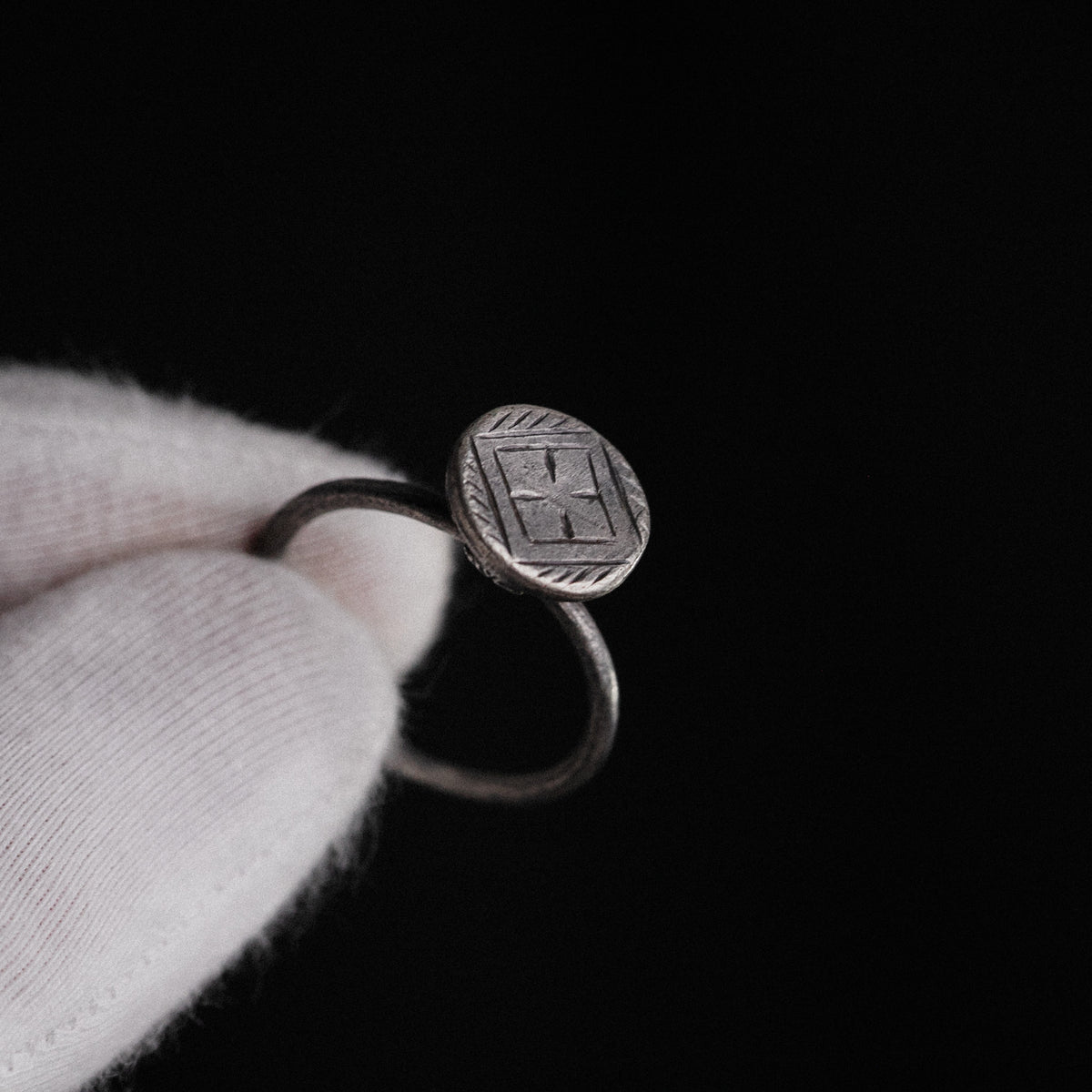 Macro detail of Byzantine silver ring Crucia engraved cross and patina