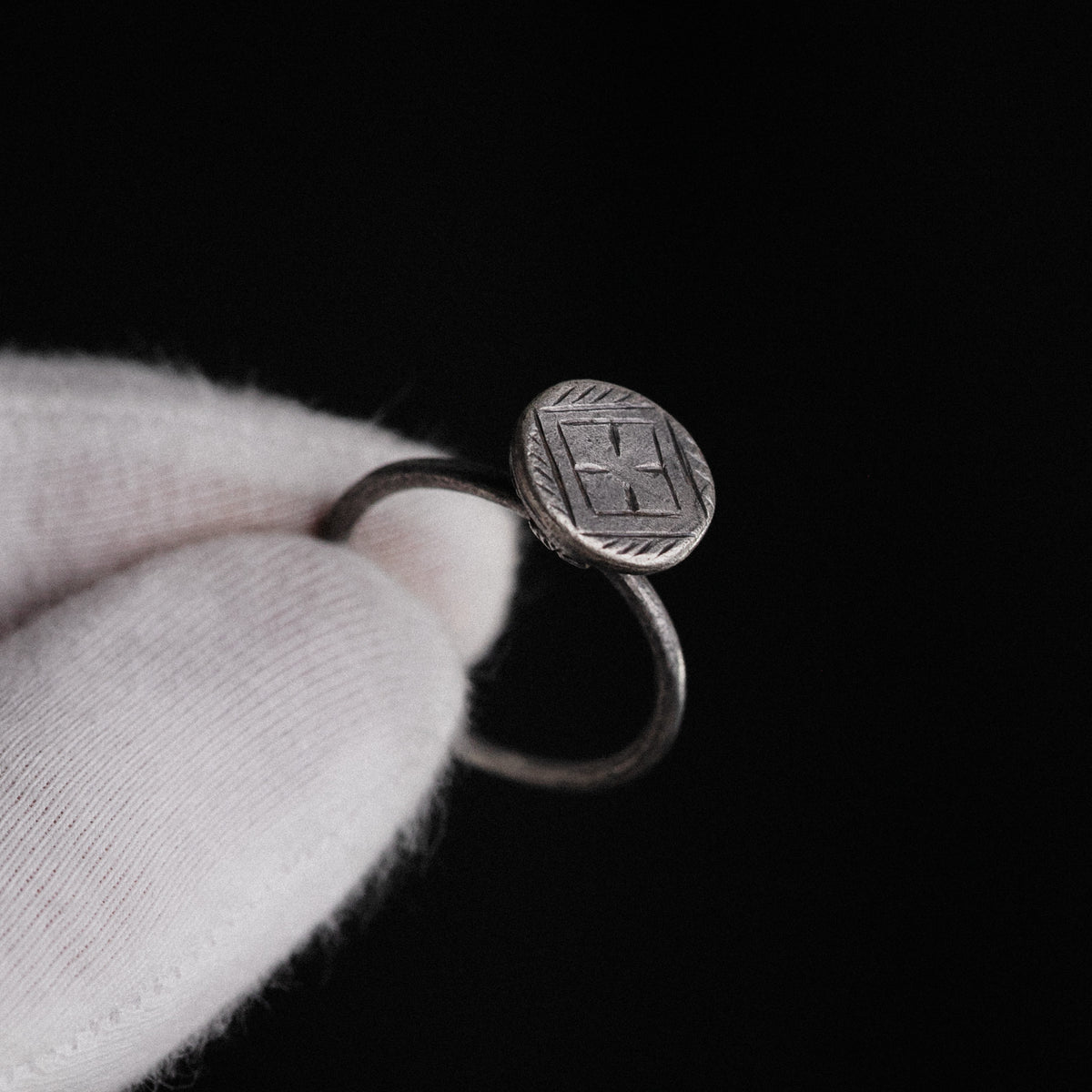 Hand-held view of Byzantine silver ring Crucia showing scale and bezel iconography