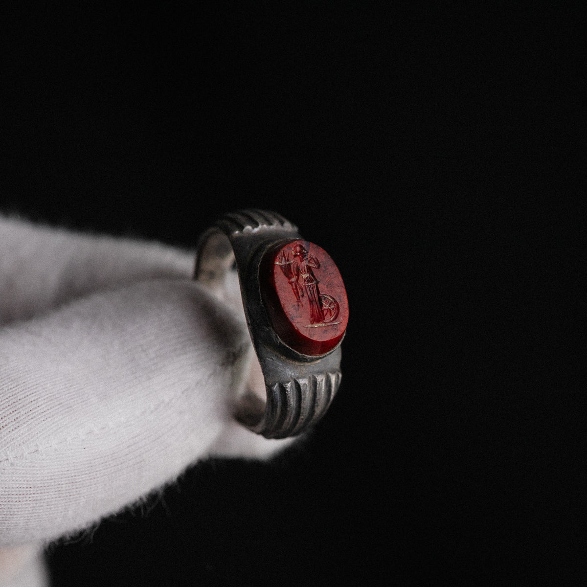 Close-up of Fortuna intaglio on Roman silver ring Fortunata with cornucopia and wheel visible