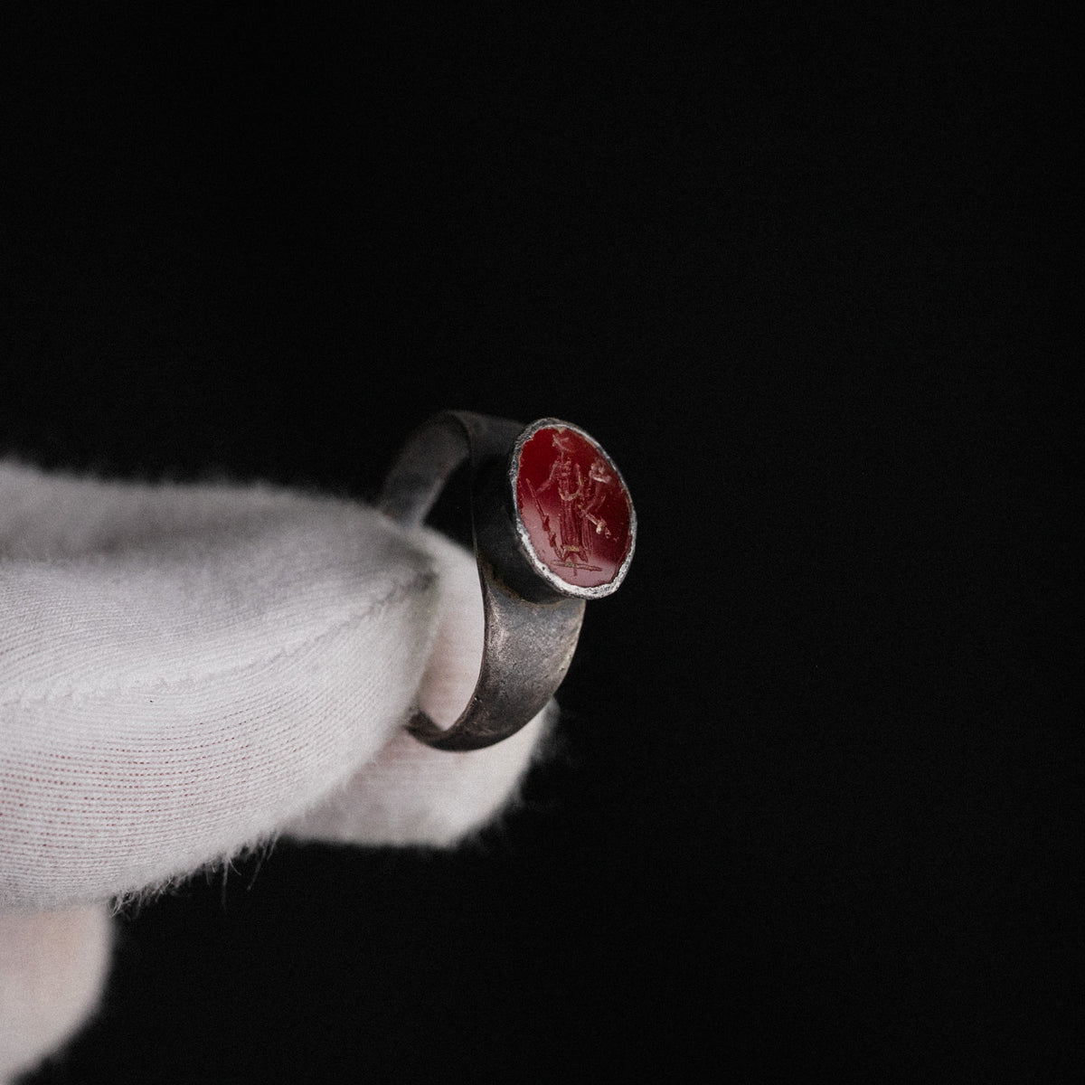 Macro detail of Sereia ring garnet intaglio showing Isis-Fortuna with modius, cornucopia and rudder